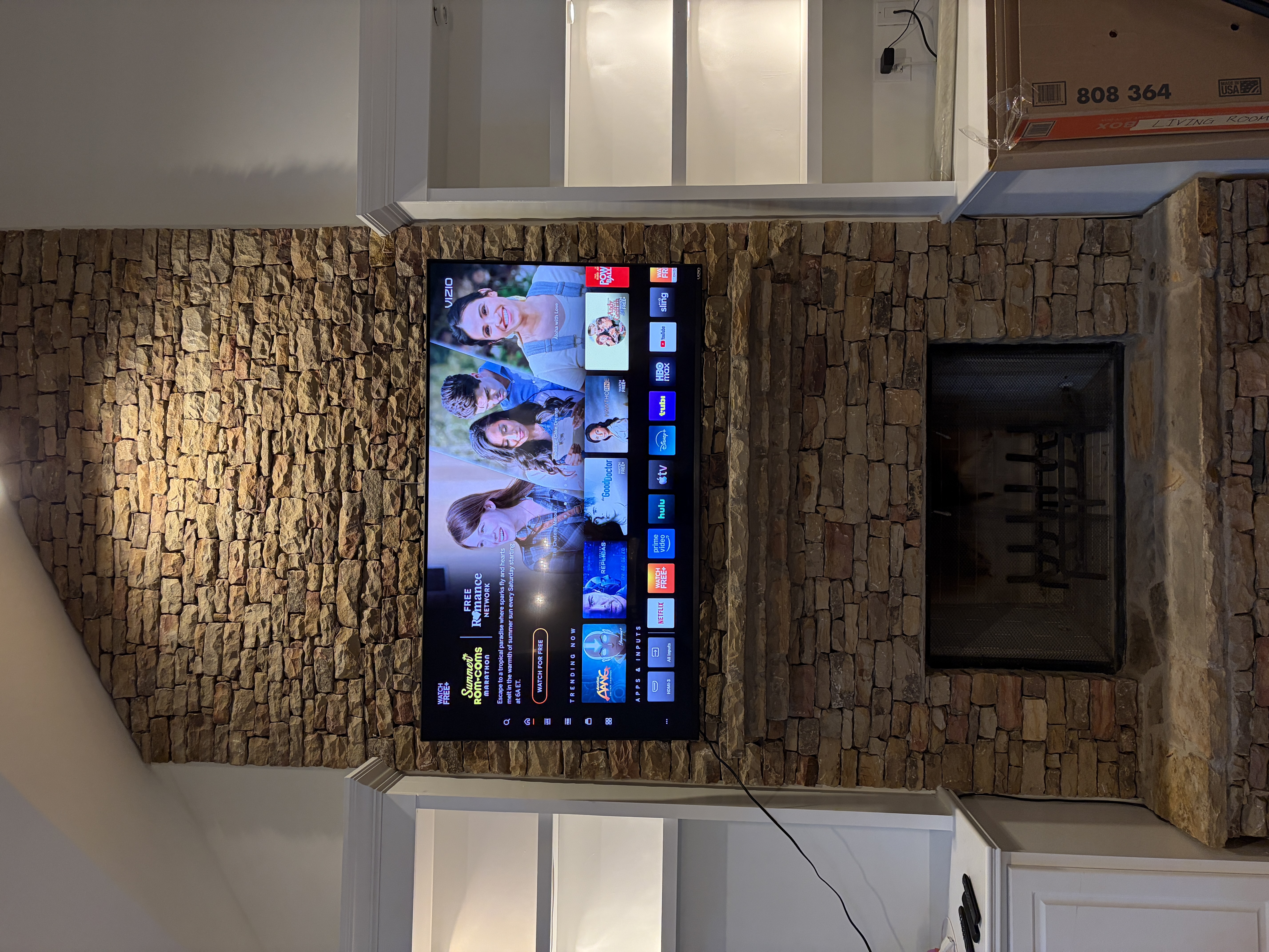 TV mounted above a fireplace mantel with concealed wiring in a North Atlanta home